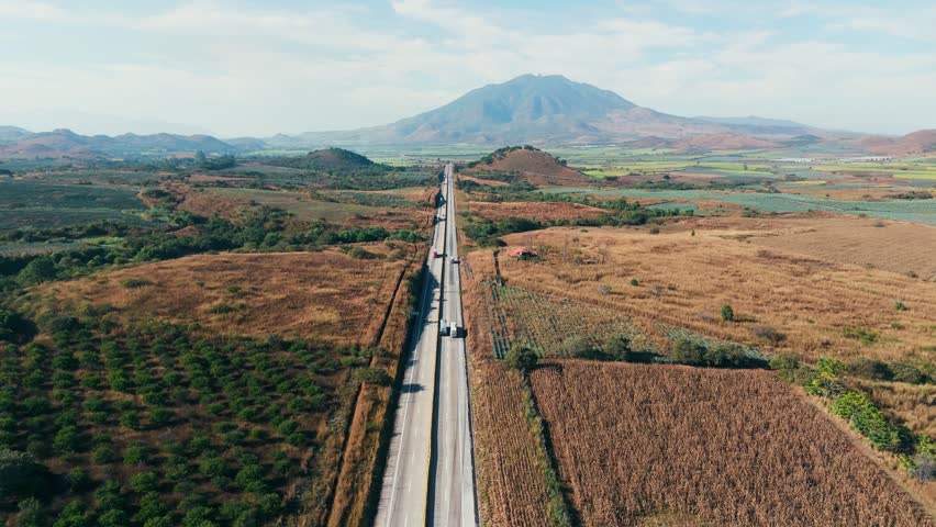 Trucks transporting goods along highway near sanganguey volcano in tepic, nayarit, mexico