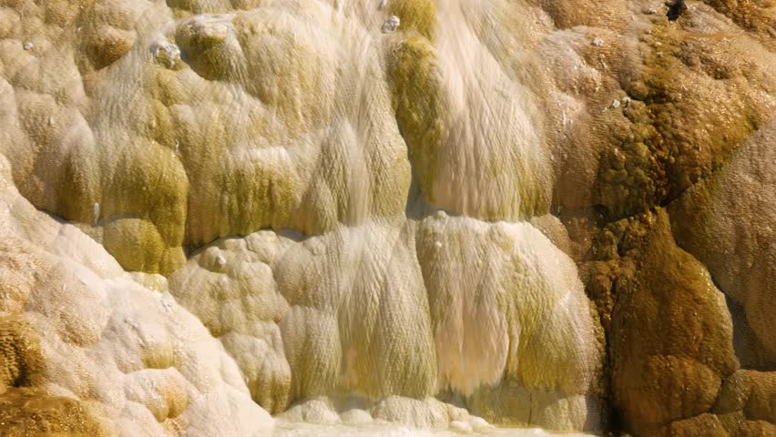 Abstract Patterns and Lahers of Colorful Travertine Springs at Mammoth Hot Springs, Yellowstone National Park. Mammoth Hot Springs is a large complex of hot springs on a hill of travertine in Yellowst