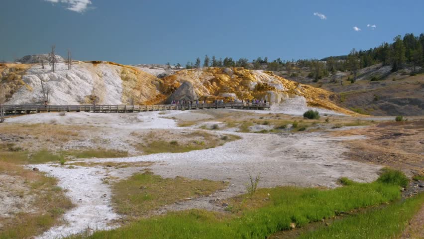 Hikers along the boardwalk near Palette Spring at Mammoth Hot Springs, Yellowstone National Park, Wyoming.