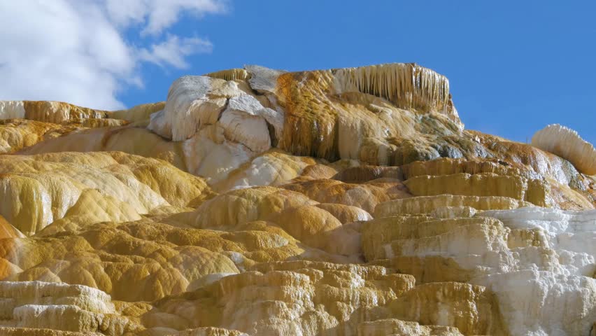 Mammoth Hot Springs is a large complex of hot springs on a hill of travertine in Yellowstone National Park adjacent to Fort Yellowstone and the Mammoth Hot Springs Historic District.