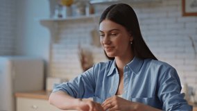 Videocalling girl examining documents talking at zoom meeting on laptop closeup. Happy lady chatting using web camera sitting at kitchen table. Smiling woman explaining project details on video call - Powered by Shutterstock - Get 15% off with code: PIKWIZARD15