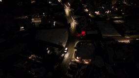 American residential area at night in winter Season. Dark City Suburb in USA. Aerial top down. Lighting houses and streetlamps on street. Birds eye flyover. Snowy roofs of homes. Quiet atmosphere. - Powered by Shutterstock - Get 15% off with code: PIKWIZARD15