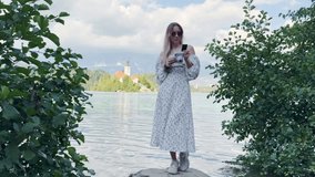 Girl in Long Dress Looking at Polaroid Photo with Mountain Lake Background - Powered by Shutterstock - Get 15% off with code: PIKWIZARD15
