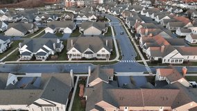 Luxury new two-story houses in modern suburb district of american town. Noble neighborhood with similar homes. Aerial lateral wide shot. Dawn sunrise scene in Winter. - Powered by Shutterstock - Get 15% off with code: PIKWIZARD15