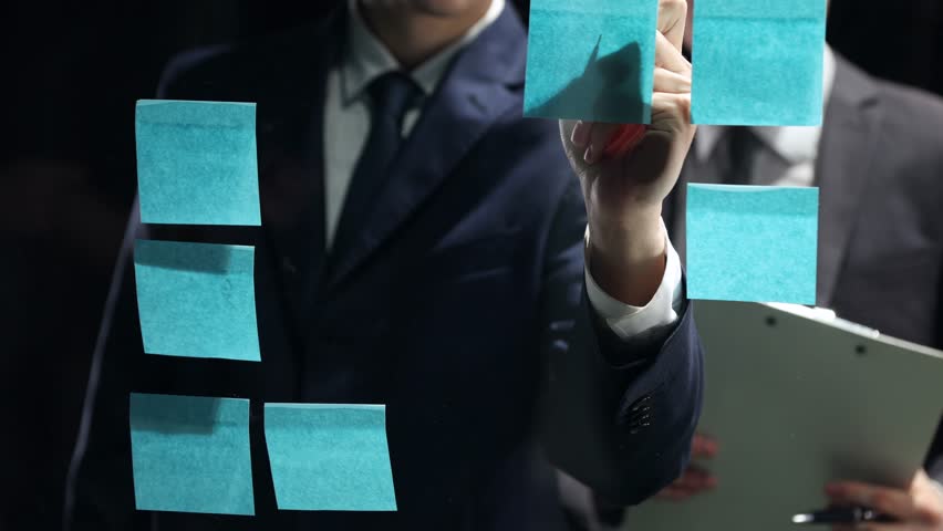 Businessmen discuss a business plan in close-up in a dark office