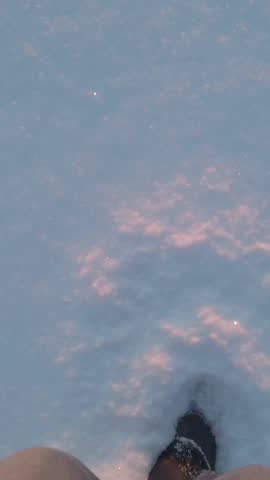 Walking in snow. Legs of man walking on snow in sunlight.