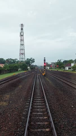 The lush green landscape is visible from the window of a fast-moving train.