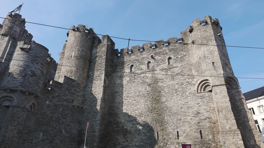 A majestic medieval castle in Ghent, Belgium, known as Gravensteen, under a sunny sky