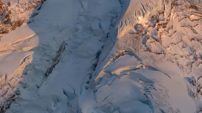 Spectacular aerial view of Mountain, Mount Baker, at sunset, showcasing the snow-capped peak and glaciers. Serene winter landscape. View from airplane, Washington, USA