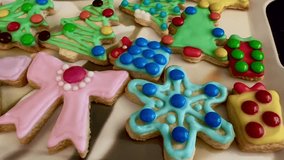 Closeup pink bow blue snowflake Christmas sugar cookies baking iced biscuits - Powered by Shutterstock - Get 15% off with code: PIKWIZARD15