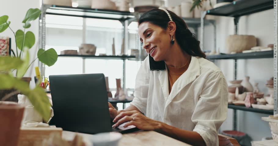 Happy woman, pottery and laptop with phone call for online order, discussion or conversation at ceramic store. Female person, artisan or small business owner talking on mobile smartphone at clay shop