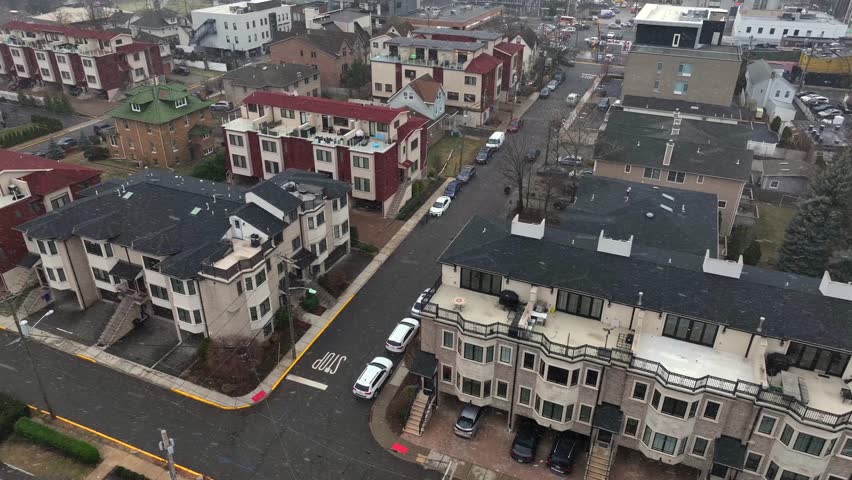 Aerial flyover American housing area in winter season. Snowstorm over american neighborhood. Rooftop terrace and modern architecture townhouses in Fort Lee, New Jersey. Top down.