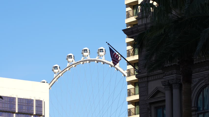 Ferris Wheel and American Flag in Las Vegas – Daytime City View. Las vegas, Nevada, USA.