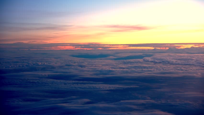 Majestic Peaks Above the Clouds: A Serene Sunrise Panorama, where golden hues illuminate towering summits, creating a breathtaking view that captures the tranquility and grandeur of nature at dawn.