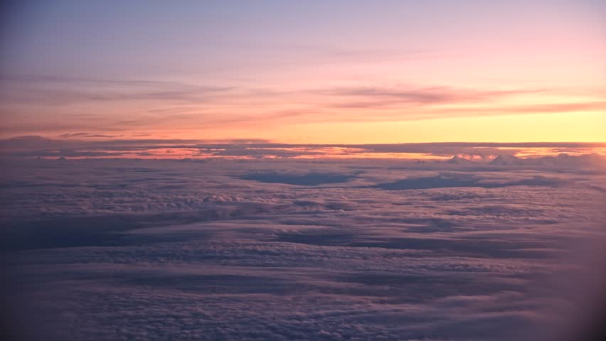 Majestic Peaks Above the Clouds: A Serene Sunrise Panorama, where golden hues illuminate towering summits, creating a breathtaking view that captures the tranquility and grandeur of nature at dawn.