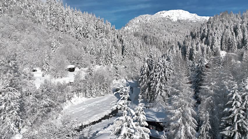 French alpine village of Chamonix in the snow, frosty winter landscape in the European Alps with alpine chalets and frozen river, ski holiday in France