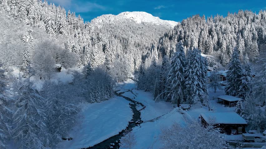 aerial view of French alpine village of Chamonix in the snow, frosty winter landscape in the European Alps with alpine chalets and frozen river, ski holiday in France. High quality 4k footage
