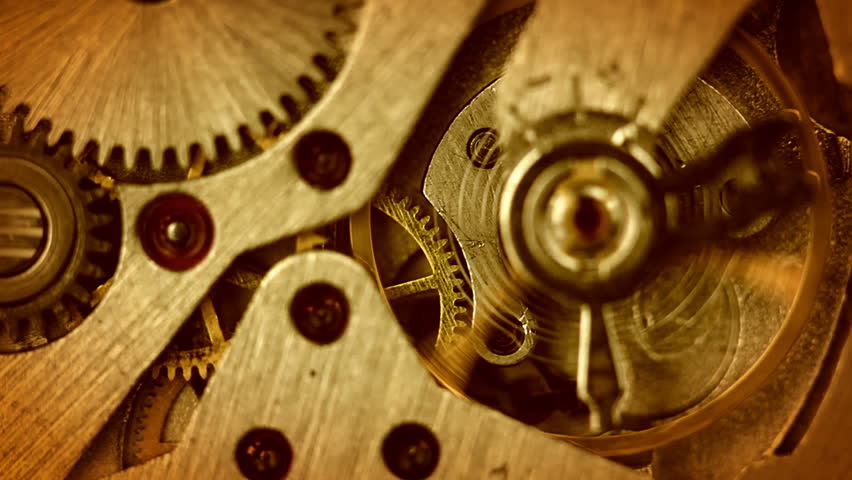 The pendulum and gears of the old watch on the move. Close-up. The focus on the