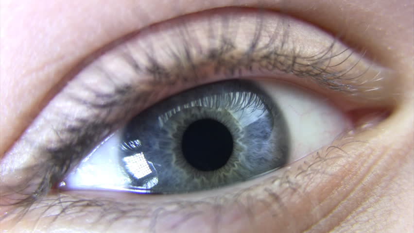 The eye of a young woman is very large. No make-up. Pupil 