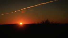 Brilliant Sunrise with Illuminated Contrail Timelapse Zoom Out - Powered by Shutterstock - Get 15% off with code: PIKWIZARD15
