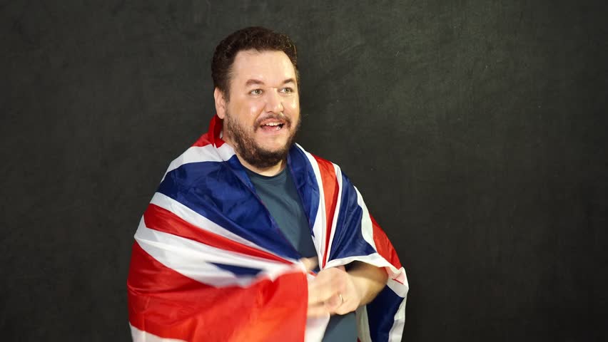 Happy man waving the British flag. Victory and excitement.