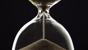 Sand running out in an hourglass, golden sand grains flowing through the glass device, timelapse shot. Time, and urgency concept. - Powered by Shutterstock - Get 15% off with code: PIKWIZARD15