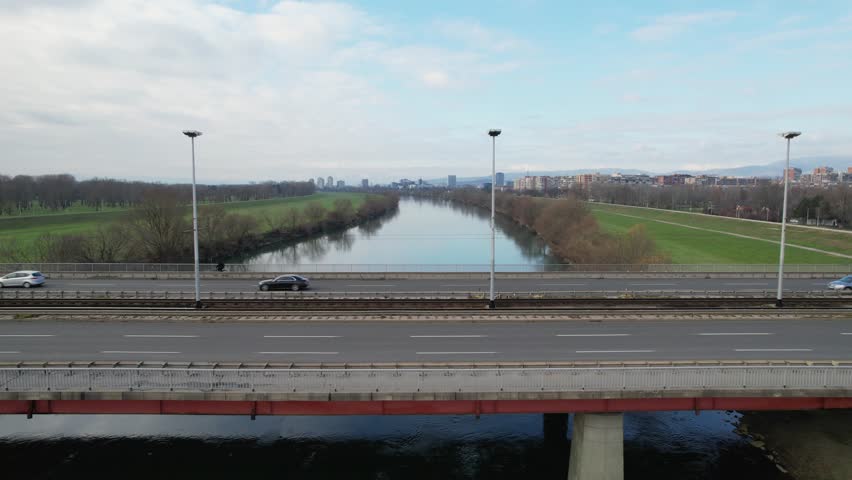 Closeup 4K aerial view of the famous Bridge of Youth (Most Mladosti) over the river Sava in Zagreb, the capital city of Croatia, with the trams and vehicles driving over it.