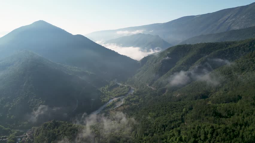 Panoramic view of the French Pyrenees, showcasing breathtaking peaks and verdant surroundings.