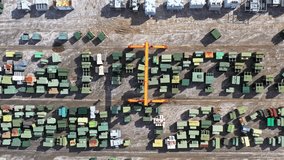 An aerial view of a slow-moving gantry crane surrounded by transformers at Maddox Industrial Transformer in South Carolina. - Powered by Shutterstock - Get 15% off with code: PIKWIZARD15