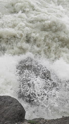 A rushing waterfall cascading down rocks, powerful water flow in Sunwapta Falls, Canada