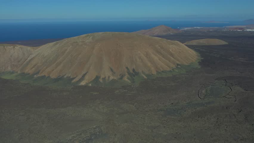 Aerial drone view of mountain sea and volcanoes in Lanzarote, Canary Islands, Spain
