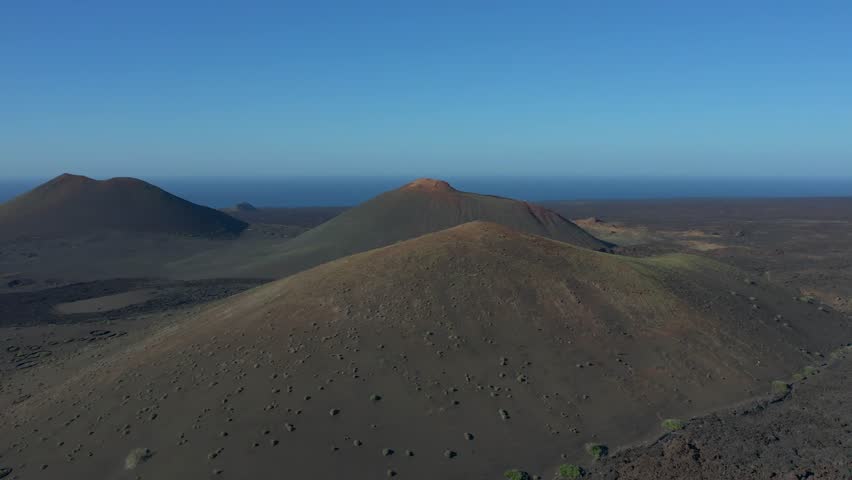 Aerial drone view of mountain sea and volcanoes in Lanzarote, Canary Islands, Spain