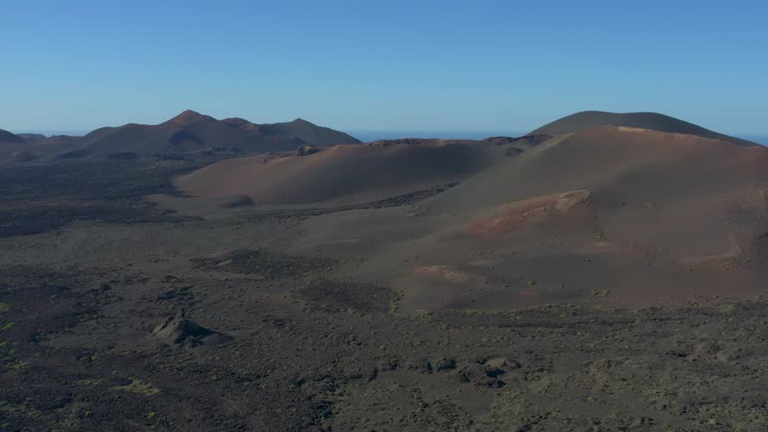 Aerial drone view of mountain sea and volcanoes in Lanzarote, Canary Islands, Spain