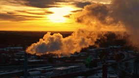 A factory chimney releasing steam or smoke during sunset, evoking industry and climate concerns - Powered by Shutterstock - Get 15% off with code: PIKWIZARD15