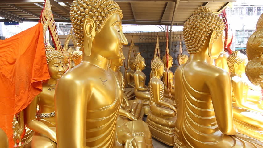 Dolly shot of golden Buddha in Thailand