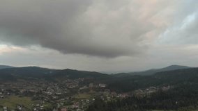 Aerial View Of Majestic Mountains And Lush Forest Under Dark Clouds. A Stunning Rainbow Appears After The Rain As The Drone Soars Through Misty Clouds, Revealing A Breathtaking Scene. - Powered by Shutterstock - Get 15% off with code: PIKWIZARD15