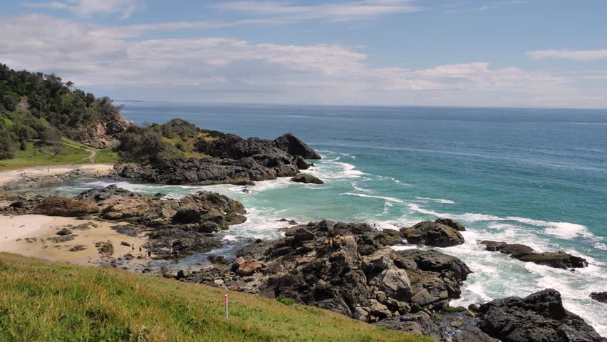 View of the rocks and ocean looking North from Tacking Point Lighthouse, Port Macquarie on a sunny day.