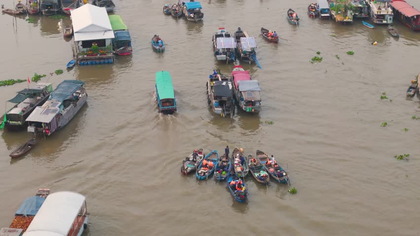 Aerial view of Cai Rang floating market, Can Tho, Vietnam. Tourists, people buy and sell food, vegetable, fruits on boat, ship at river market in Tet Holiday.