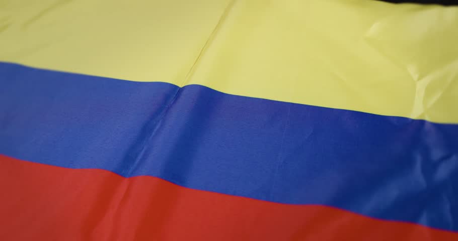 A vibrant Colombian flag billows in the wind, evoking pride