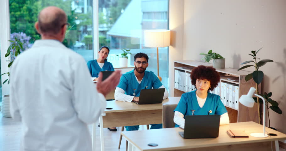 Doctor, nurse and interns with laptop for presentation, lesson or studying at medical practice. Healthcare, employees or junior students learning with surgeon for health training or nursing course