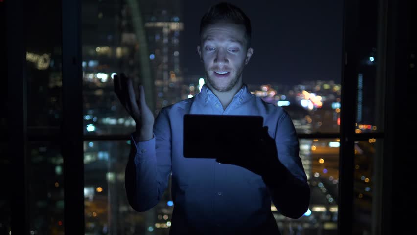 A Productive Male Entrepreneur inside his Office with a Touch Pad on his Hand