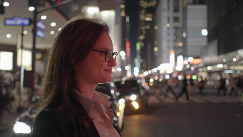 Smart Phone Capturing Her Attention as a Woman Moves through the Streets