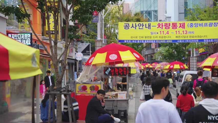 Busan , South Korea - 11 09 2024: Korean Market Street, Pan Shot over Food Stalls and People