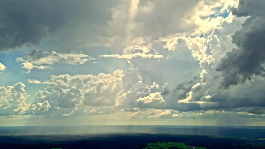 Beautiful clouds in the sky moving with the wind and the rays of sunlight passing through the clouds