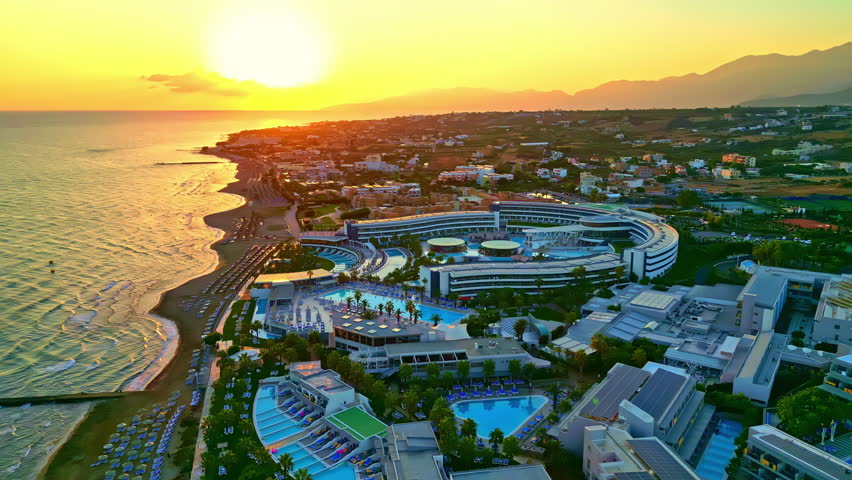 Aerial panoramic view over the town and beaches of Analipsi in Greece.