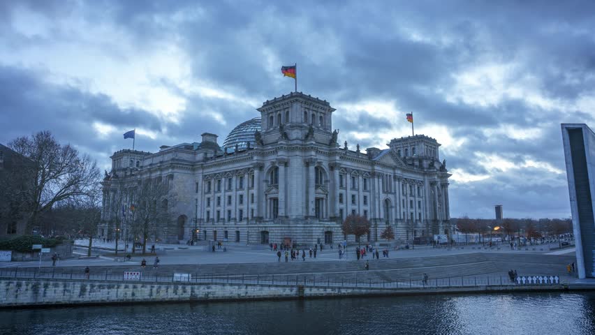 Day to night timelapse of the deutscher bundestag (reichstag) parliament building in berlin, germany, europe.