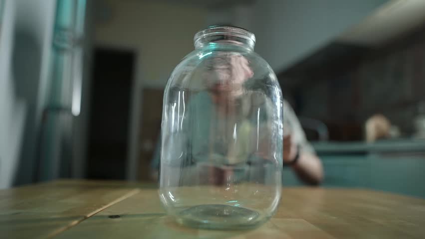 Saving money with a jar for financial goals in a kitchen setting