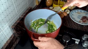 A person frying asparagus with garlic in a pan with olive oil - Powered by Shutterstock - Get 15% off with code: PIKWIZARD15