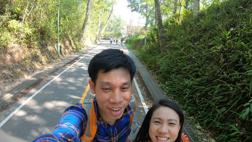 A cheerful snapshot of two friends enjoying a walk on a scenic nature trail. The bright smiles and lush greenery create a vibrant atmosphere, showcasing the joy of spending time outdoors and the beaut