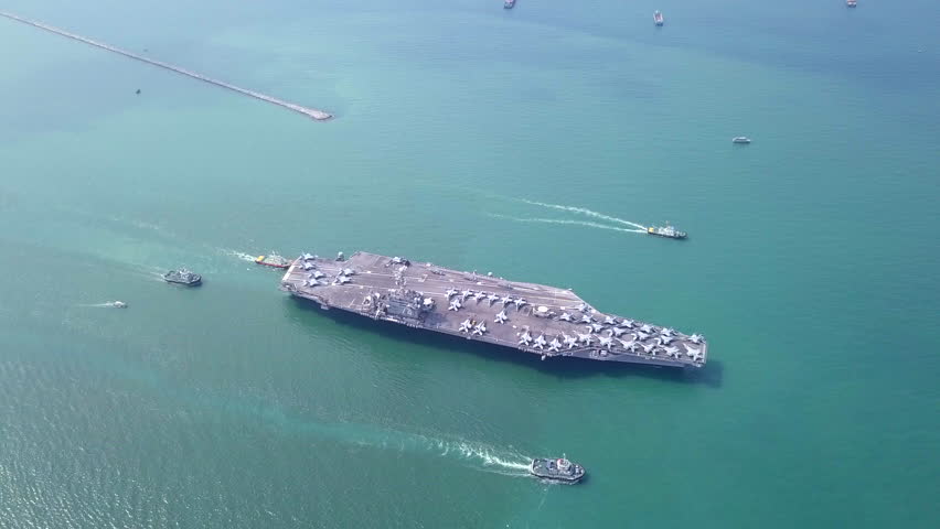 Aircraft carriers, warships, nuclear-powered ships, carrying a large number of aircraft sailing at sea.